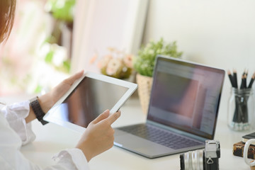 Unrecognizable businesswoman using a tablet on desk