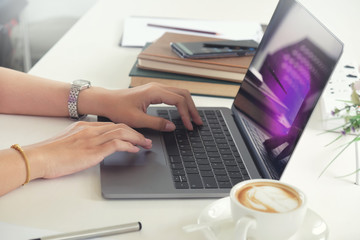 Cropped shot of medical worker typing on laptop in office.