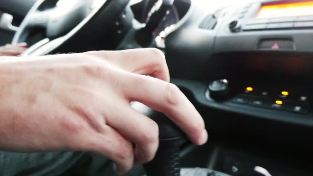 Male Hand Changing Car Gear. Driver Shifting Gear In Car.