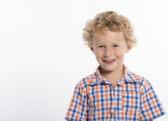 Adorable little boy in plaid shirt on white background, smiling at camera