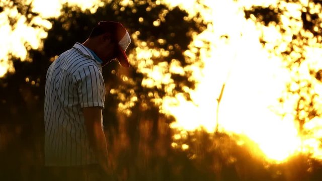 Men are hitting the baseball player with the sunset footage slow motion