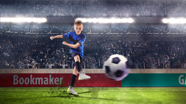 football player kid kicking the ball on the stadium