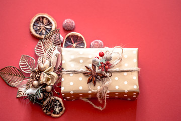 Fototapeta na wymiar Christmas concept, gift box with decor on red background