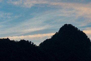 Fototapeta premium sunset behind silhouette of mountain range at mount sanqing