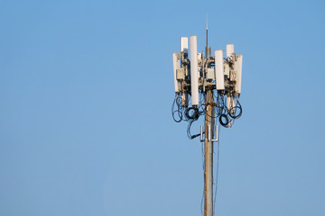 Obraz premium A top of a cell phone tower on blue sky