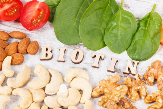Inscription biotin with healthy products as source minerals, vitamin B7 and fiber, nutritious eating concept