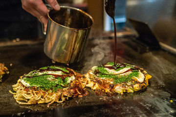 Fototapeta premium okonomiyaki is almost done on the iron plate