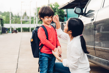 Family happy mother send children kid son boy kindergarten to school