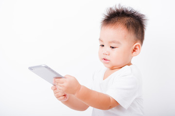 Fototapeta premium Asian portrait child boys 1 year 6 months holding smartphone