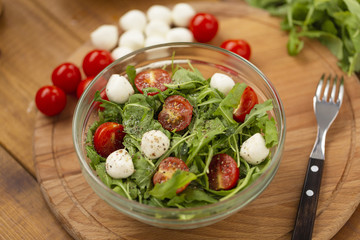 Arugula with mozzarella, tomatoes and olive oil, Caprese salad.