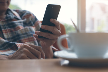 Man using smart phone in cafe