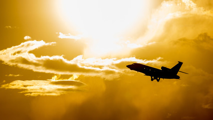 A flying airliner in the evening sky-a contour photography in the backlight. Contre-jour is a photographic technique in which the camera is pointing directly toward a source of light.