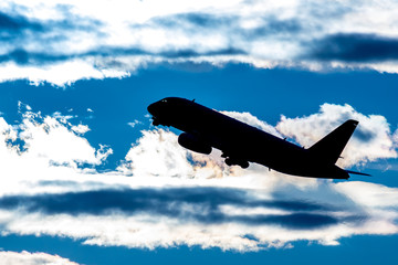 A flying airliner in the evening sky-a contour photography in the backlight. Contre-jour is a photographic technique in which the camera is pointing directly toward a source of light.
