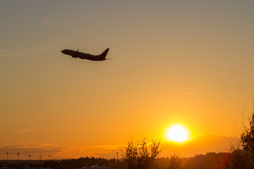 A flying airliner in the evening sky-a contour photography in the backlight. Contre-jour is a photographic technique in which the camera is pointing directly toward a source of light.