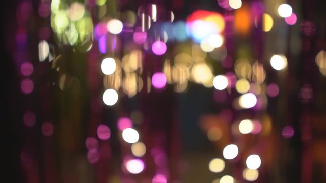 abstract defocused colorful pink and gold bokeh or bubble from blinker light party at night for background and merry christmas with happy new year festival or pub