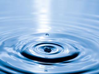 Naklejka na ściany i meble close up drop of water on blue background