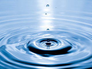 close up drop of water on blue background