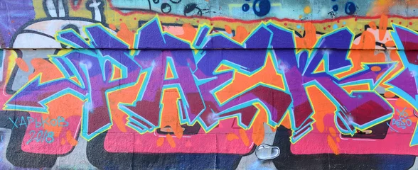 Fragment von Graffiti-Zeichnungen. Die alte Mauer ist mit Farbflecken im Stil der Straßenkunstkultur dekoriert. Farbige Hintergrundtextur in violetten Tönen © mehaniq41