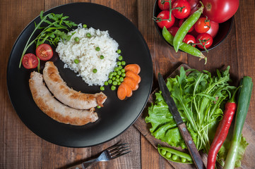 Sausages on plate with boiled rice