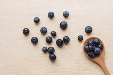 blueberry with wood spoon on wooden background. for healthy food concept.
