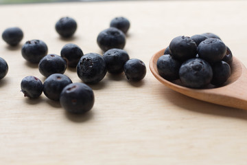 blueberry with wood spoon on wooden background. for healthy food concept.