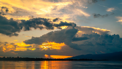 Naklejka na ściany i meble Scenic view of Mekong river against sky during sunset image