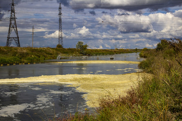 Fototapeta na wymiar waste water from the power plant polluting substances entering the natural river