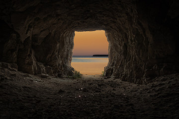 Exit from the cave overlooking the evening sea.