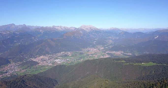 4K Drone aerial view to the Seriana valley and Orobie Alps in a clear and blue day. View of the highest mountains. Landscape from Pizzo Formico Mountain, Bergamo, Italy
