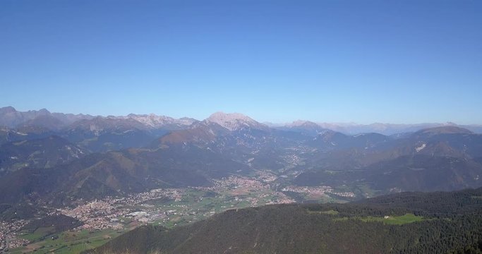4K Drone aerial view to the Seriana valley and Orobie Alps in a clear and blue day. View of the highest mountains. Landscape from Pizzo Formico Mountain, Bergamo, Italy