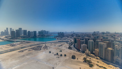 Aerial skyline of Abu Dhabi city centre from above during all day timelapse