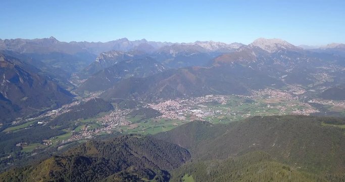 4K Drone aerial view to the Seriana valley and Orobie Alps in a clear and blue day. View of the highest mountains. Landscape from Pizzo Formico Mountain, Bergamo, Italy