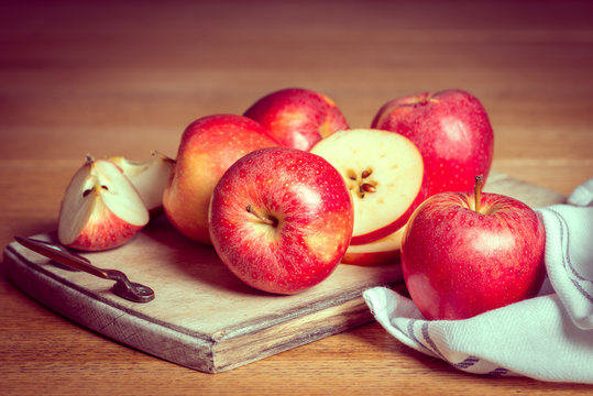 Red Apples On Rustic Chopping Board