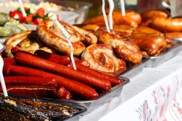 Assortment of grilled sausages for sale. Street food, fast food
