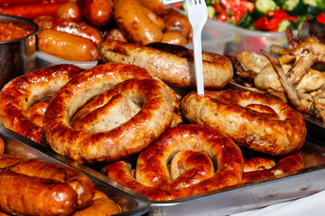 Assortment of grilled sausages for sale. Street food, fast food