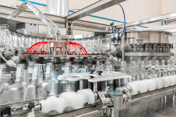 on the conveyor belt glass bottles. factory shop for the production of glass bottles and beverage