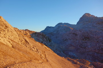 Sunrise on a hiking trail leading to the top of mount Triglav in Triglav national park, Julian Alps, Slovenia