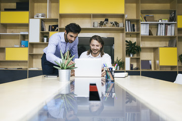Two young businessmen working  at office