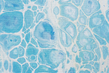 Beautiful background of liquid acrylic in blue and white on canvas