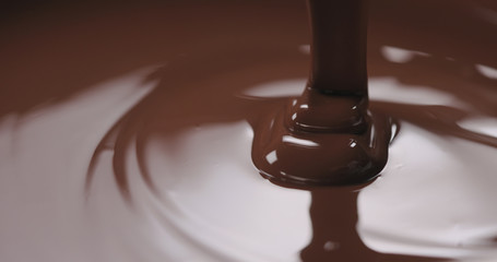 closeup pouring molten dark chocolate