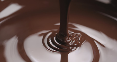 closeup pouring molten dark chocolate