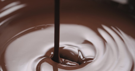 closeup pouring molten dark chocolate