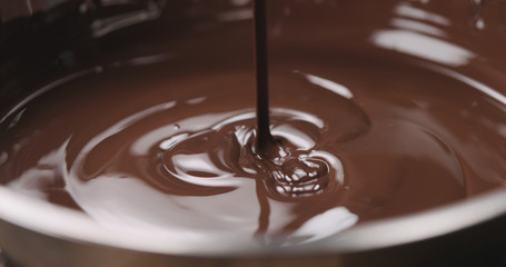 closeup pouring molten dark chocolate
