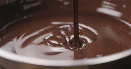 closeup pouring molten dark chocolate