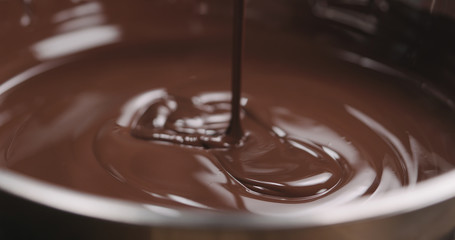 closeup pouring molten dark chocolate