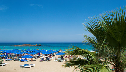 Local municipal beach is overwhelmed with people on sunny day in Protaras, Cyprus on June 16, 2018. 