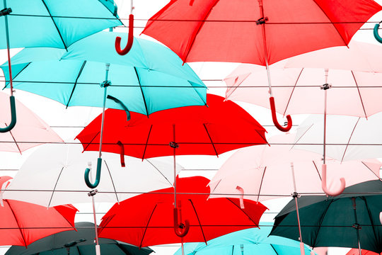 Abstract background of red, blue, pink and black umbrellas