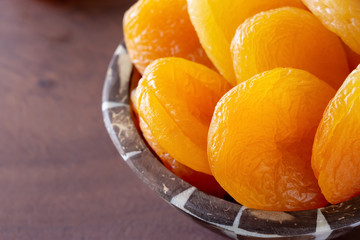 Turkish jumbo dried apricots in wooden bowl. Healthy snack concept.