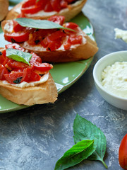 Italian bruschetta with chopped tomatoes, basil and cheese on grilled crusty bread