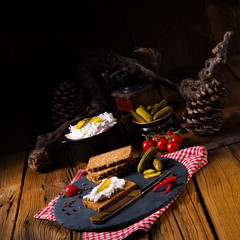 delicious spicy meat salad with cucumber on the black bread